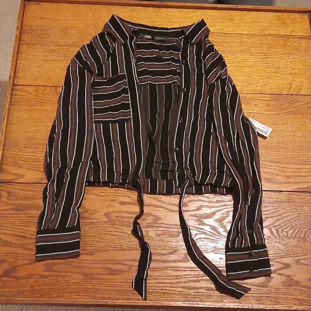 Striped button up shirt with tie strings at the bottom, button details on sleeve